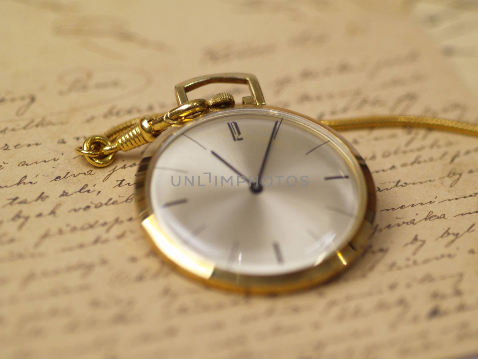 pocket watch over old postcards