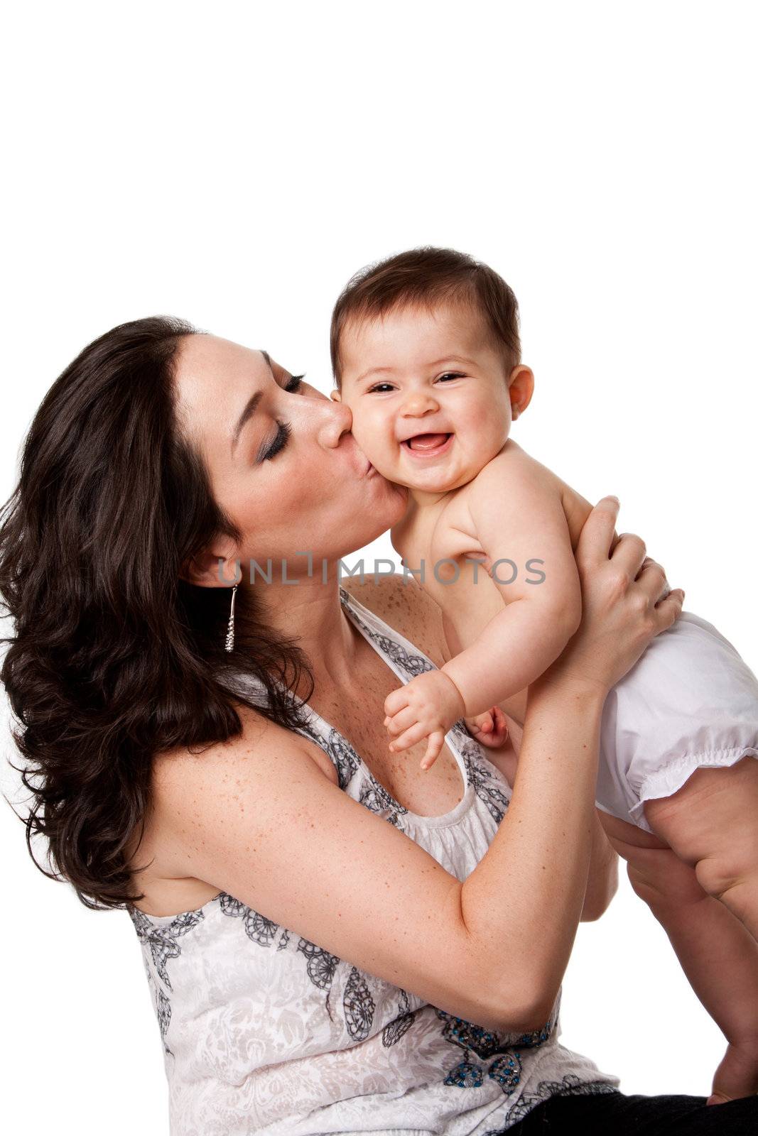 Beautiful mother kissing happy smiling laughing baby on cheek, isolated.