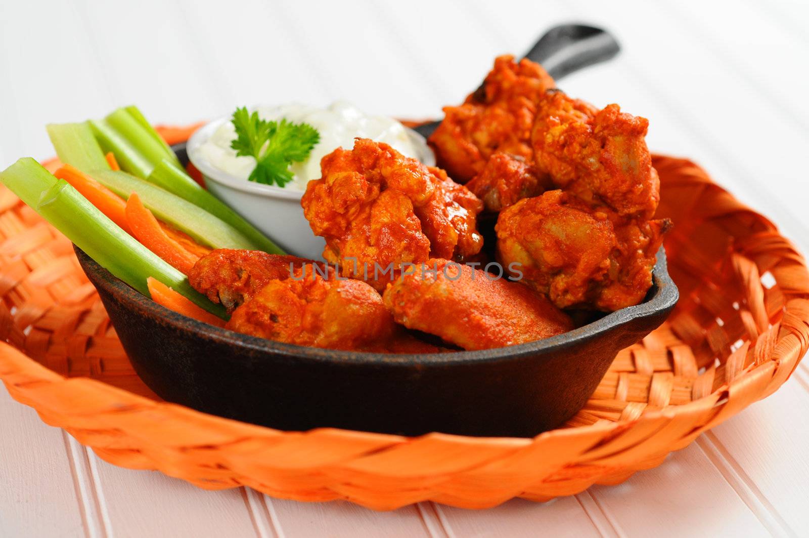 Buffalo style chicken wings and fresh vegetables.