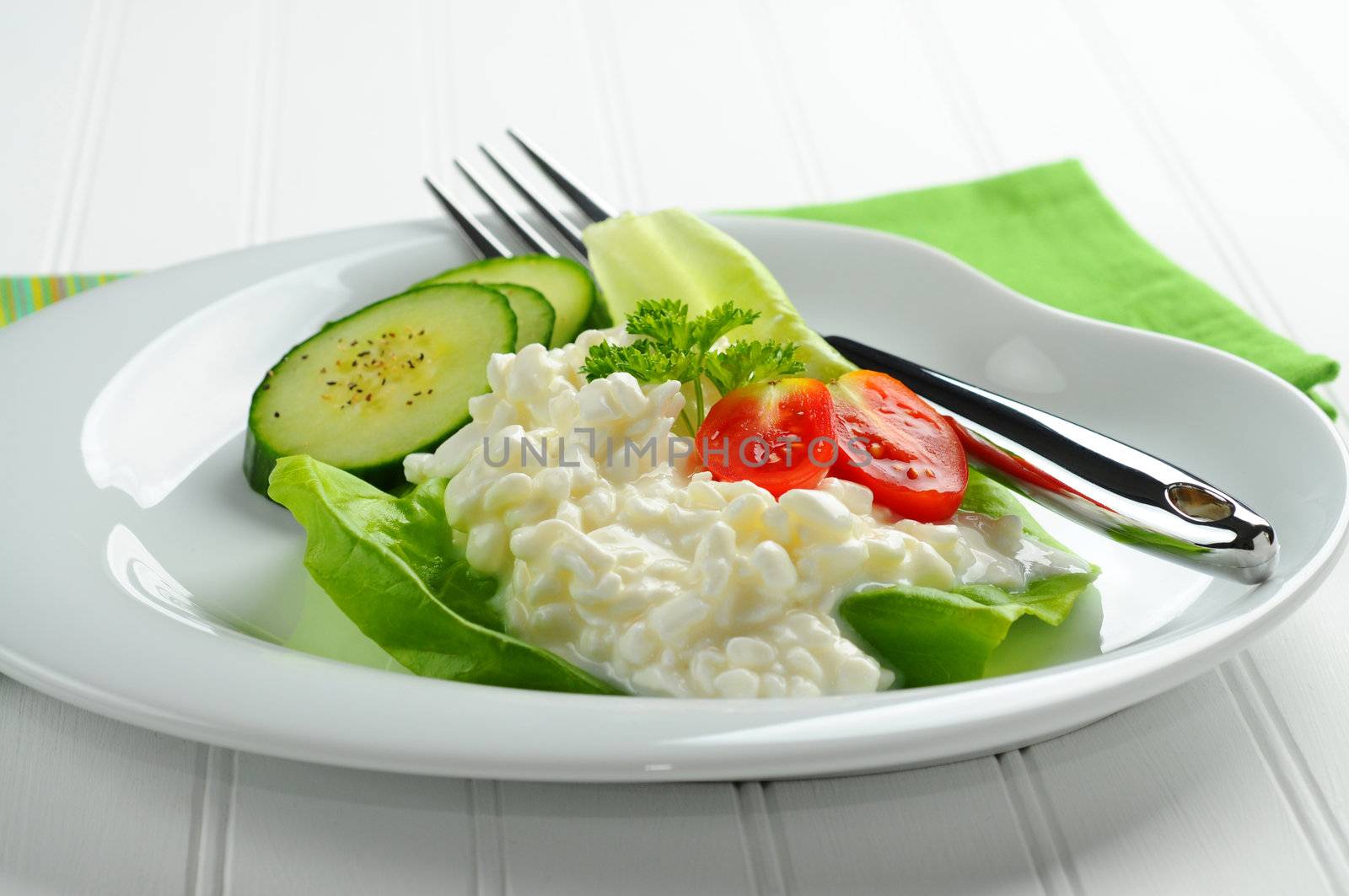 Plate with cottage cheese and fresh vegetables.