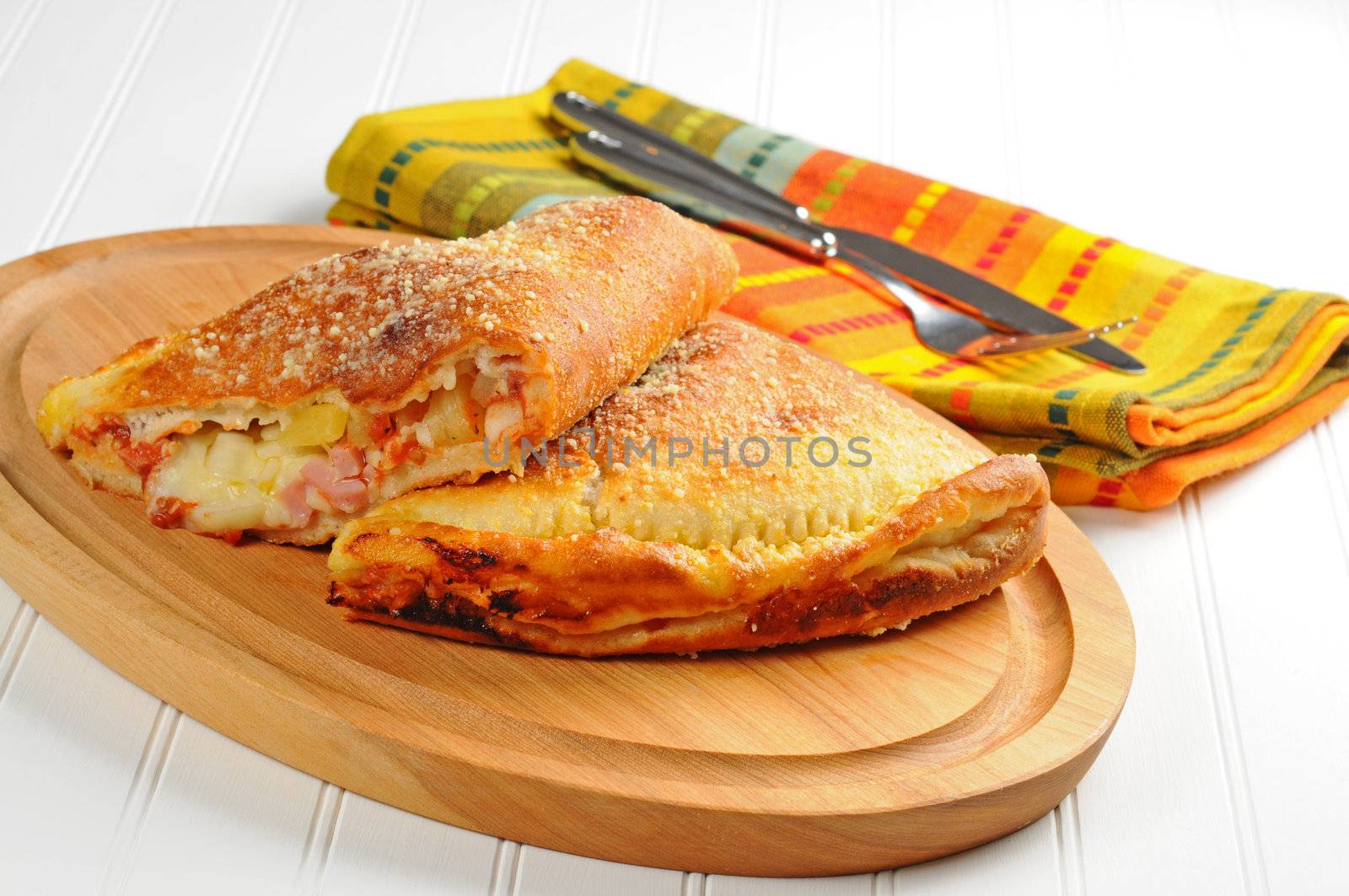Homemade baked panzarotti with ham and pinapple.