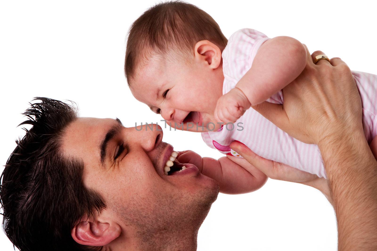 Handsome Caucasian Hispanic father holding cute baby daughter in air having fun and laughing smiling, isolated;