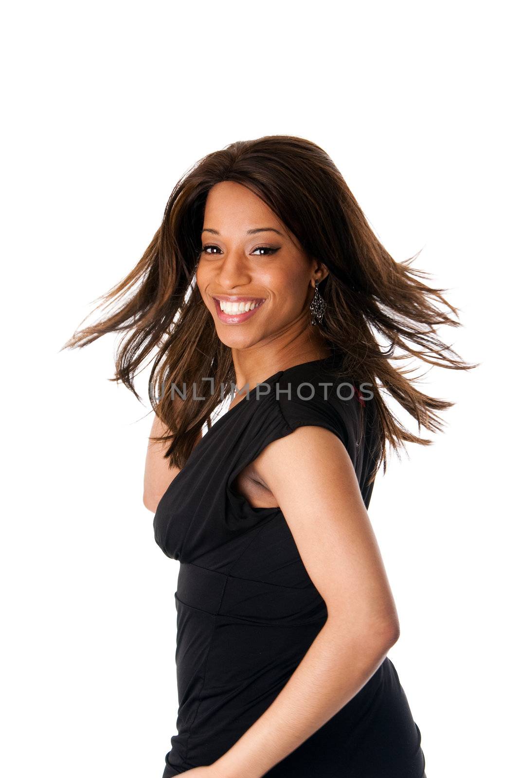 Beautiful happy smiling African American business woman in black dress swirling and twirling her long hair while turning head, isolated.