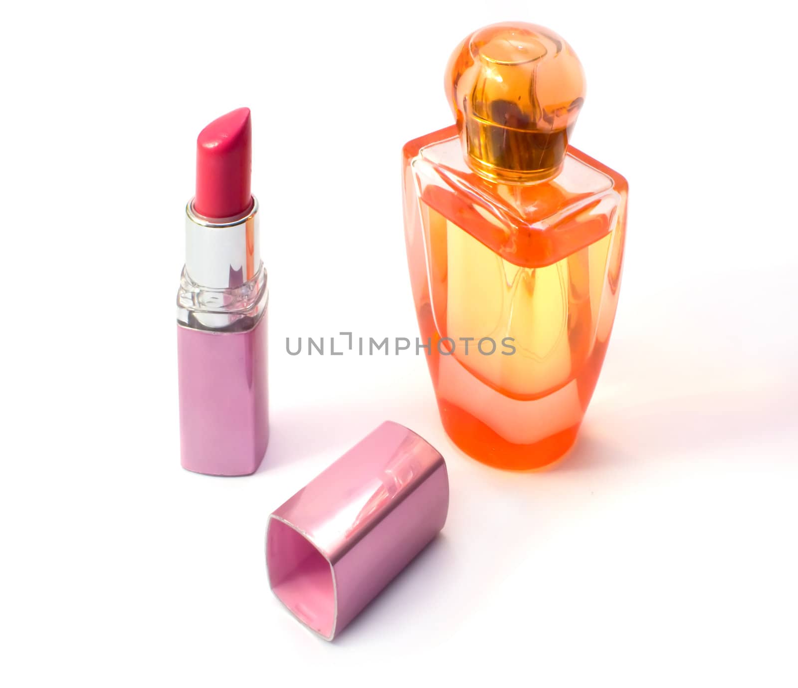 Lipstick and perfume bottle. Photo close up on a white background.