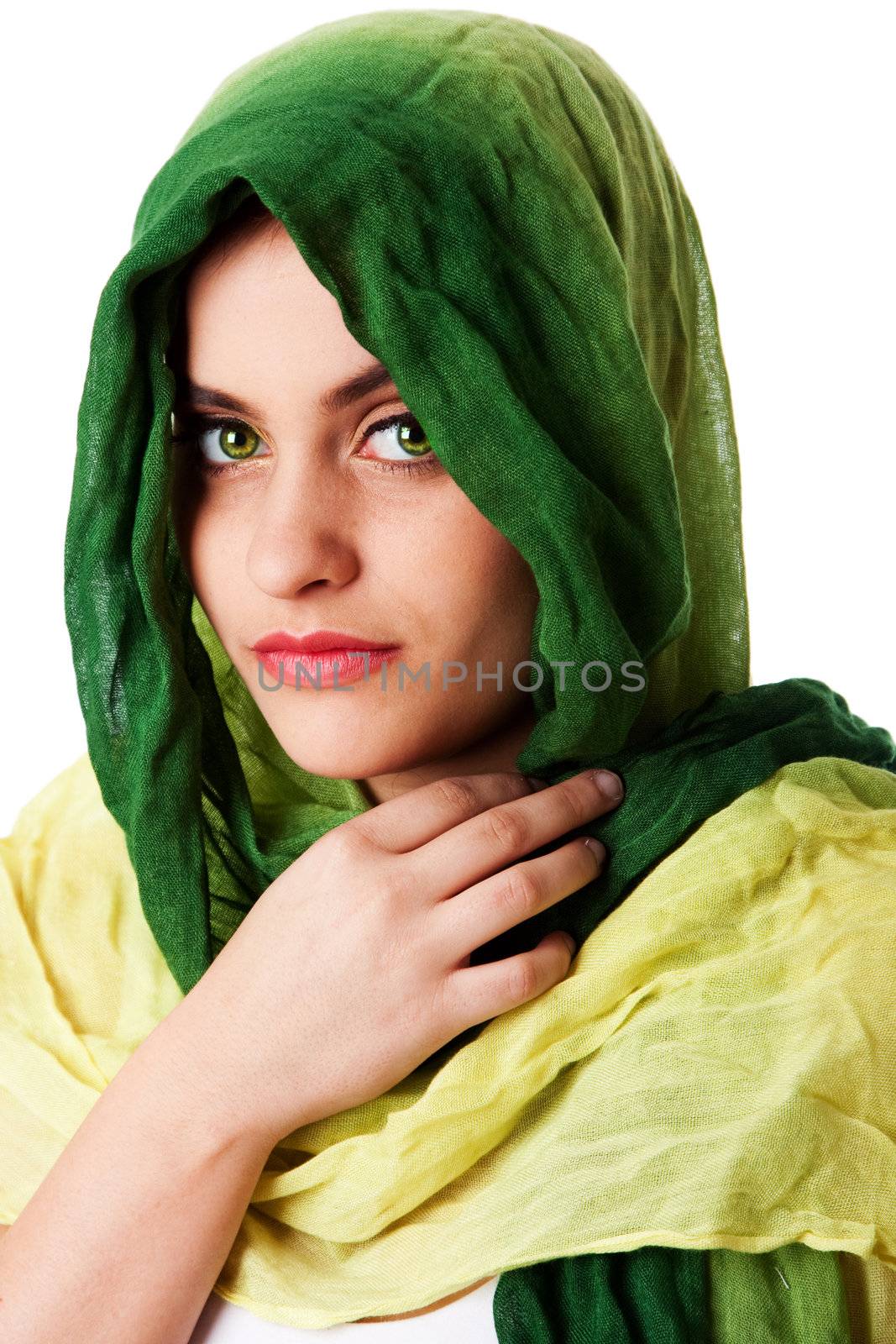 Portrait of mysterious beautiful Caucasian Middle Eastern woman face with green penetrating eyes and green fashion scarf wrapped around head, isolated.