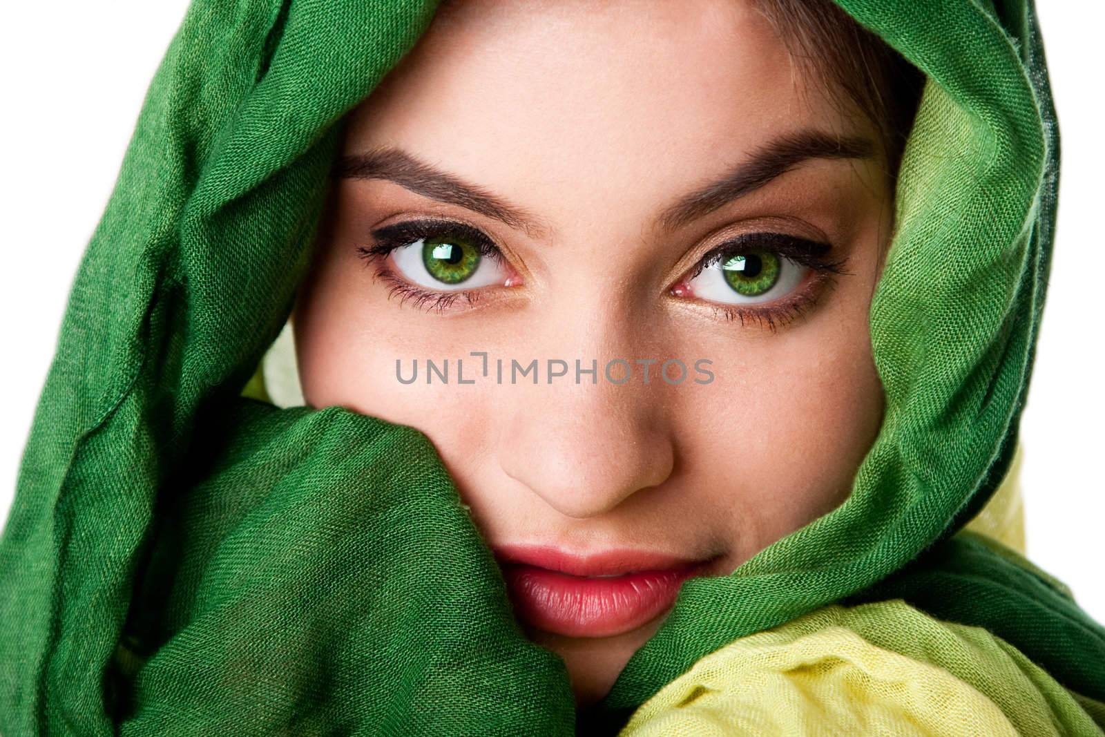 Portrait of mysterious beautiful Caucasian Hispanic Latina woman face with green penetrating eyes and green fashion scarf wrapped around head, isolated.