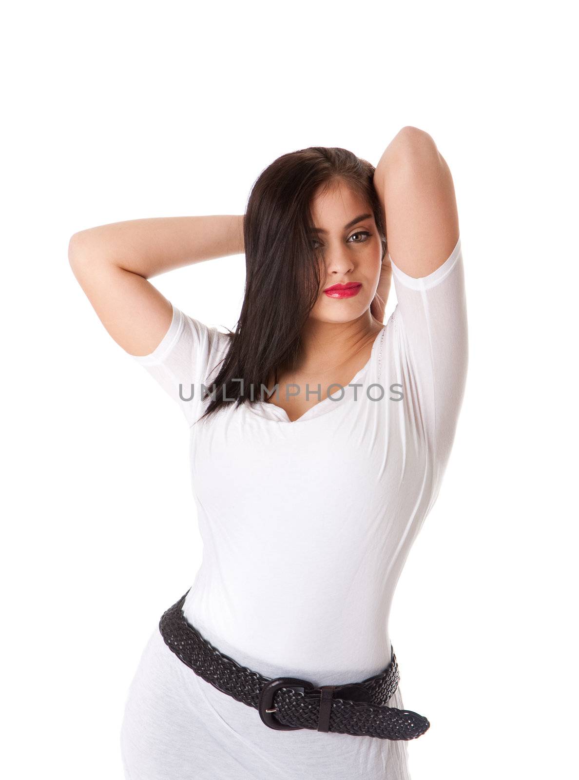 Beautiful brunette Caucasian Hispanic Latina woman with red lipstick standing with hands behind head, wearing white shirt, isolated.