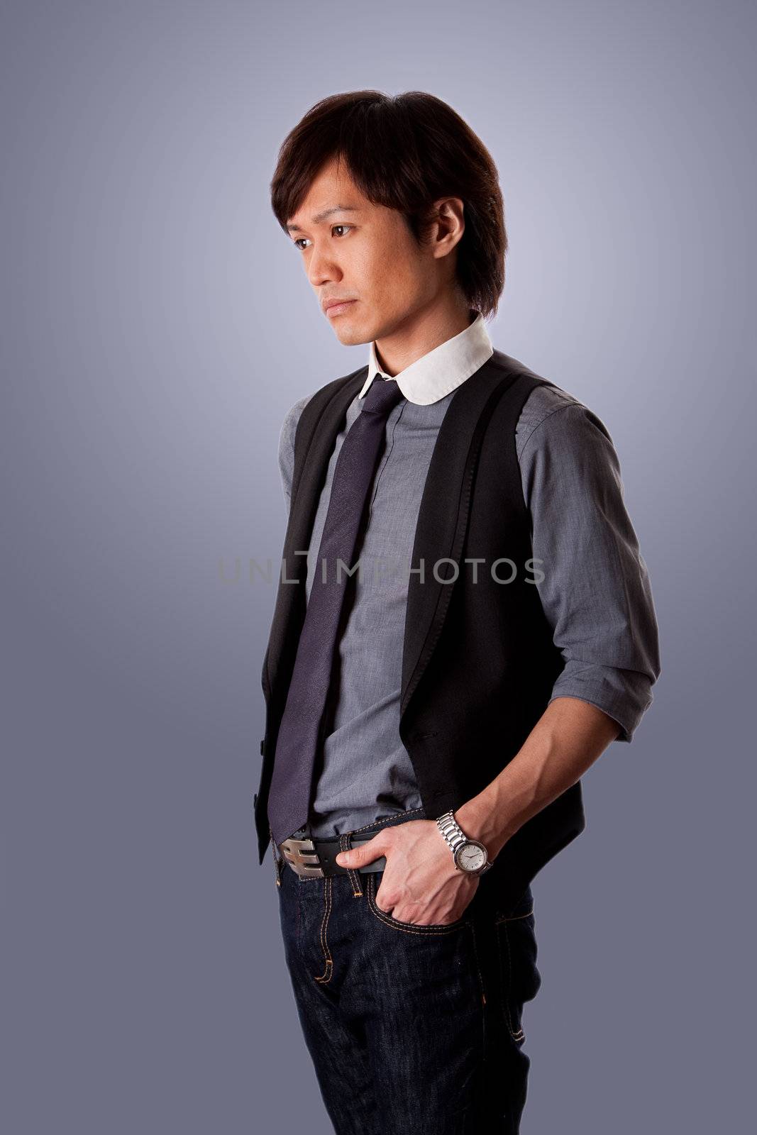 Depressed casual Asian business man with sad look, side view, wearing jeans and dress shirt with tie, isolated.