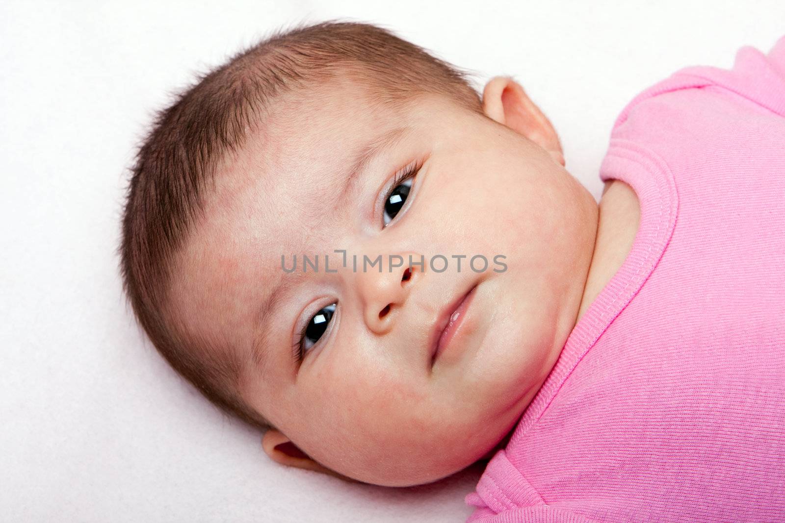Cute Caucasian Hispanic Latina baby face. Beautiful head of a newborn infant.