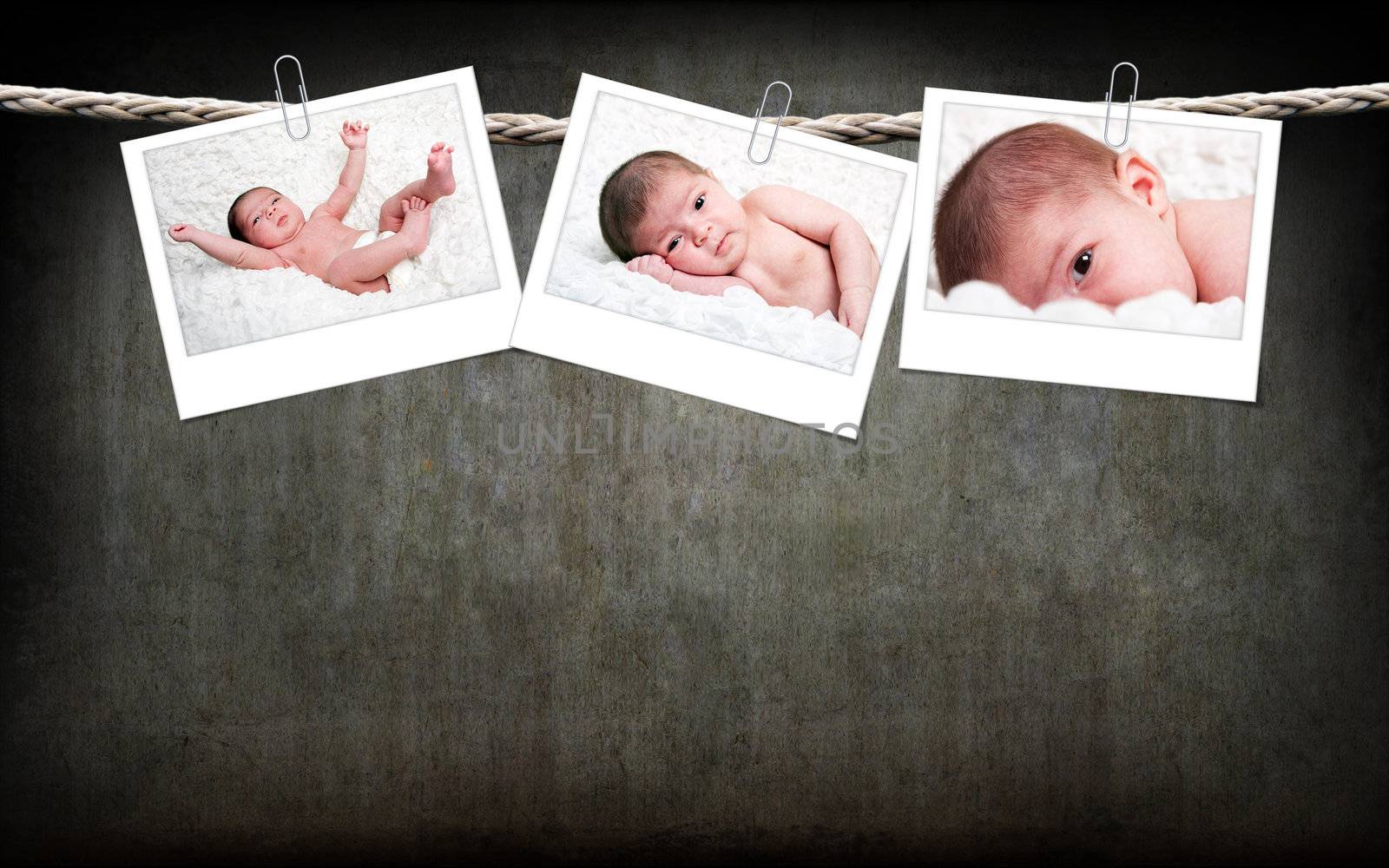 Cute baby photos hanging on rope by phakimata