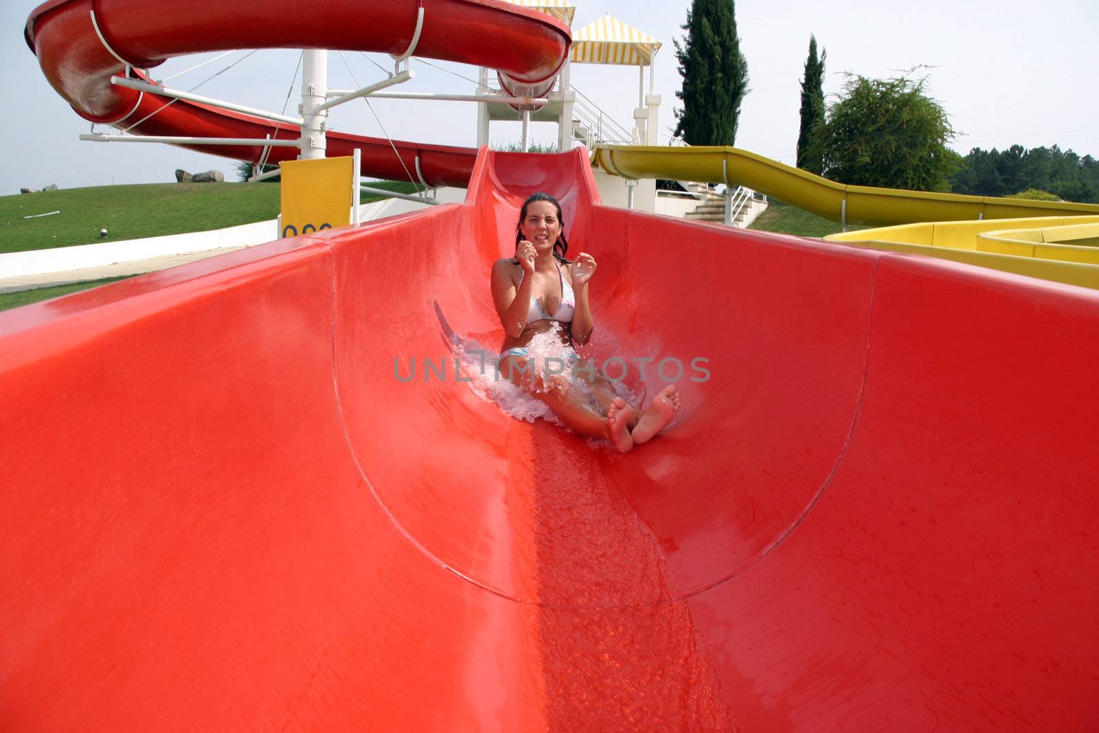girl in swimming pool water slide by jpcasais