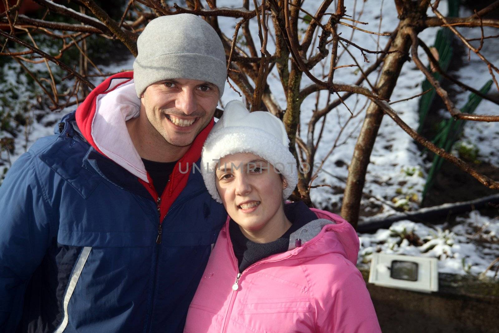 happy couple playing in the snow