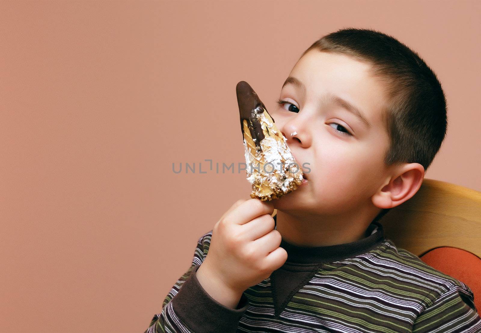 Portrait of a boy eating a cake