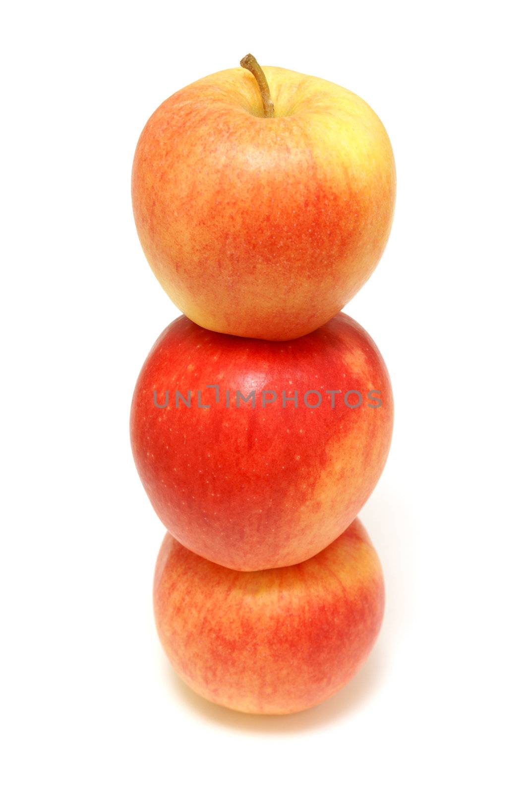 Three red apples stacked on top of each other.