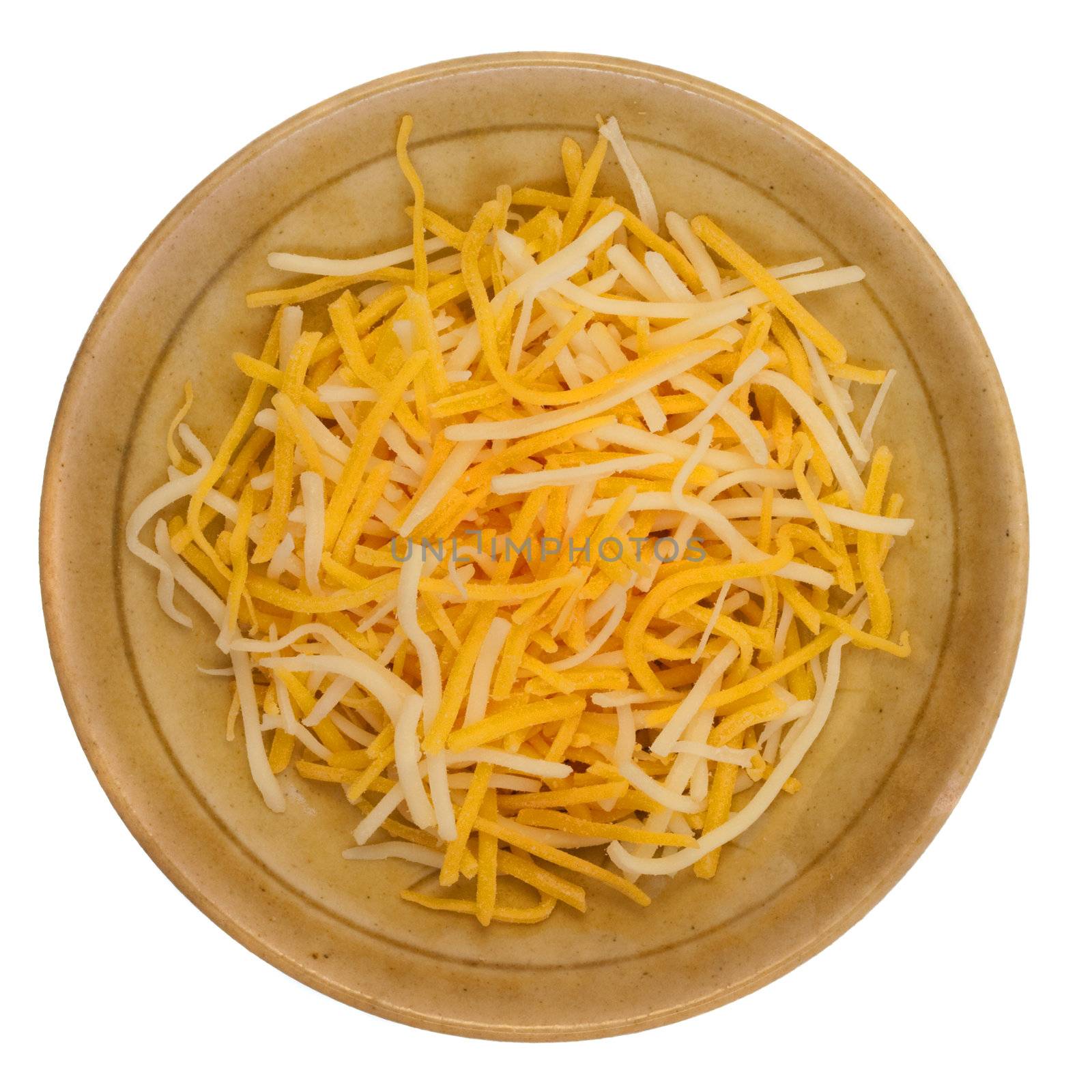 shredded cheddar and Monterey Jack cheese on a small ceramic bowl isolated against white background
