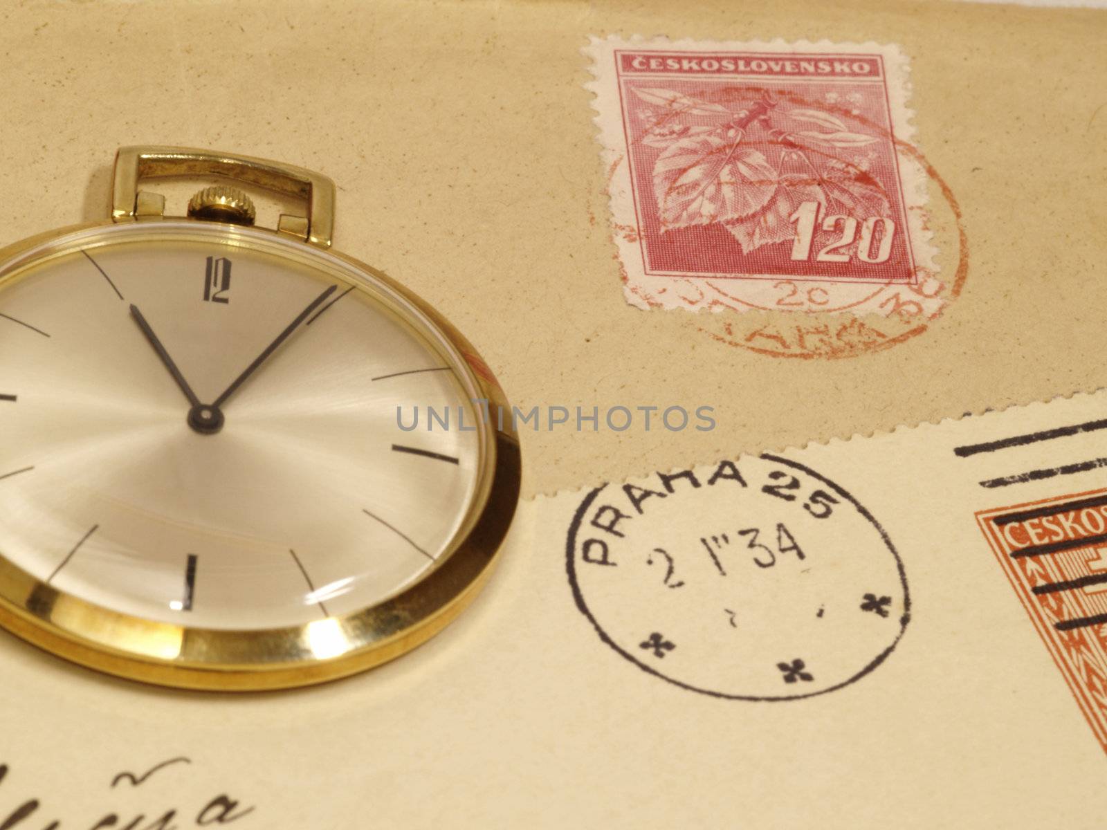 pocket watch over old postcards