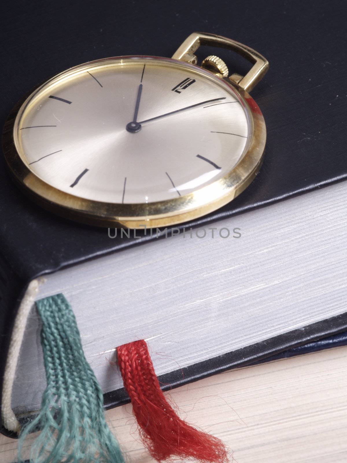 pocket watch over old books