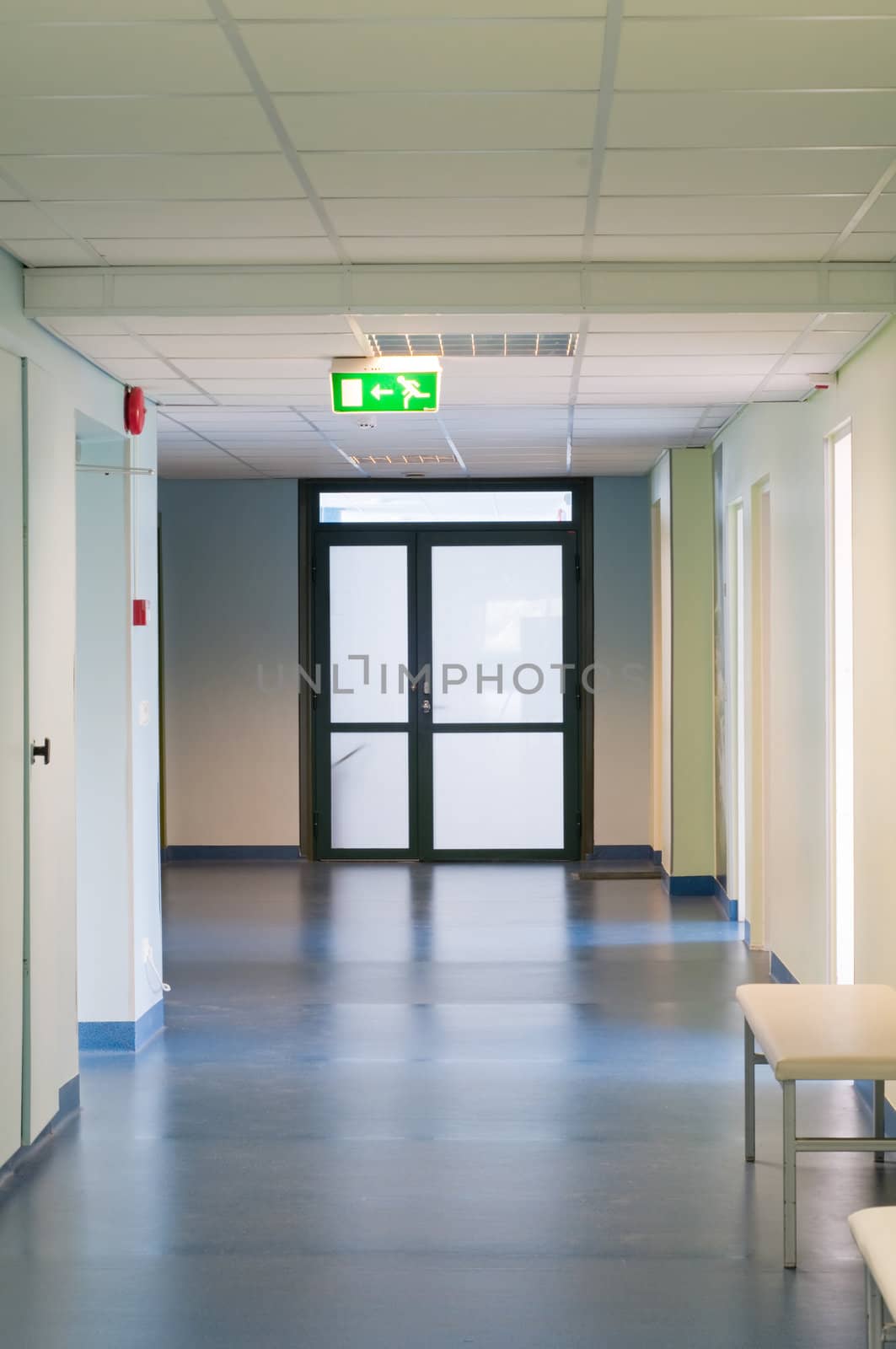 Long corridor in hospital with doors and reflections 
