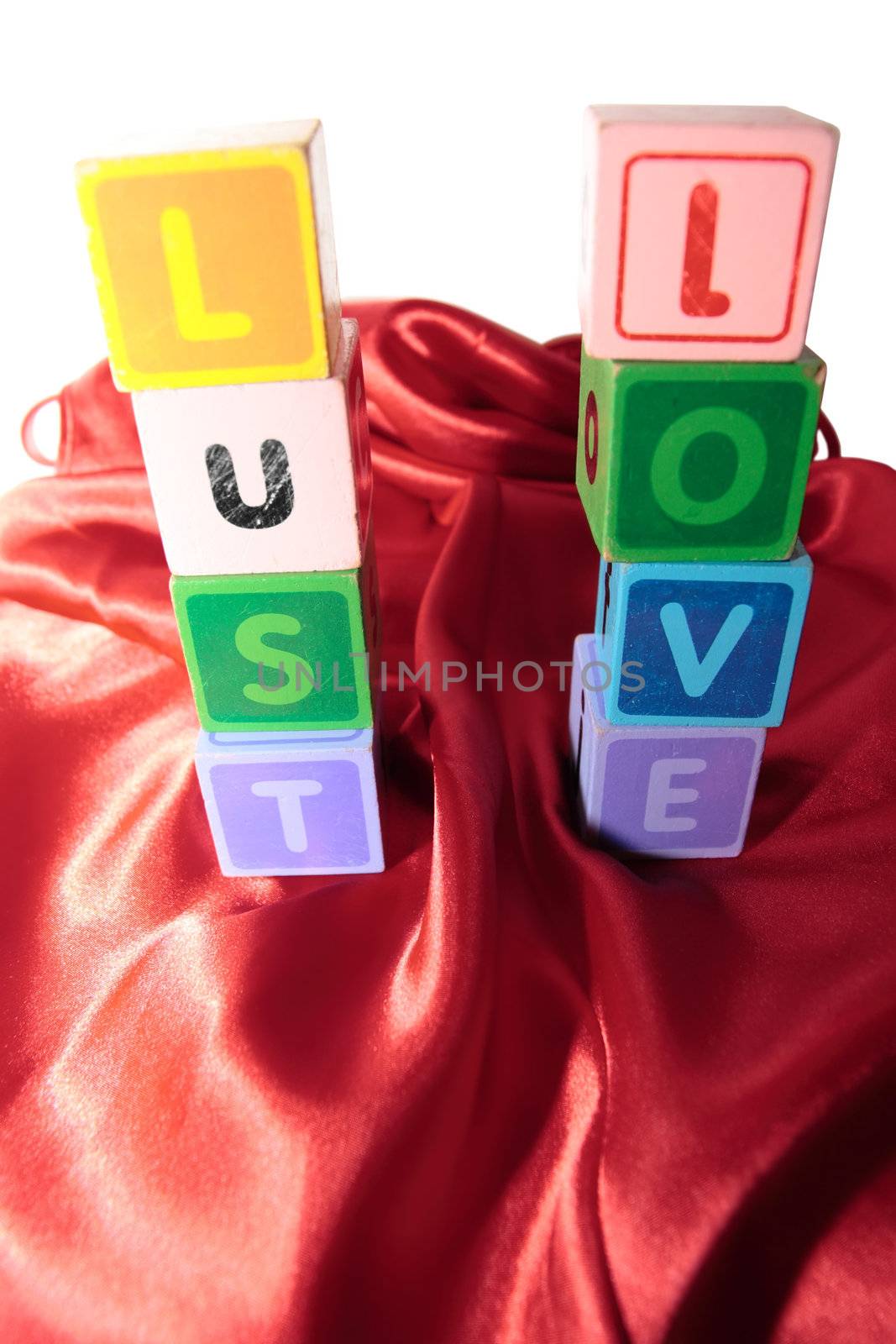 lust and love written with blocks on a silk nightie against white background