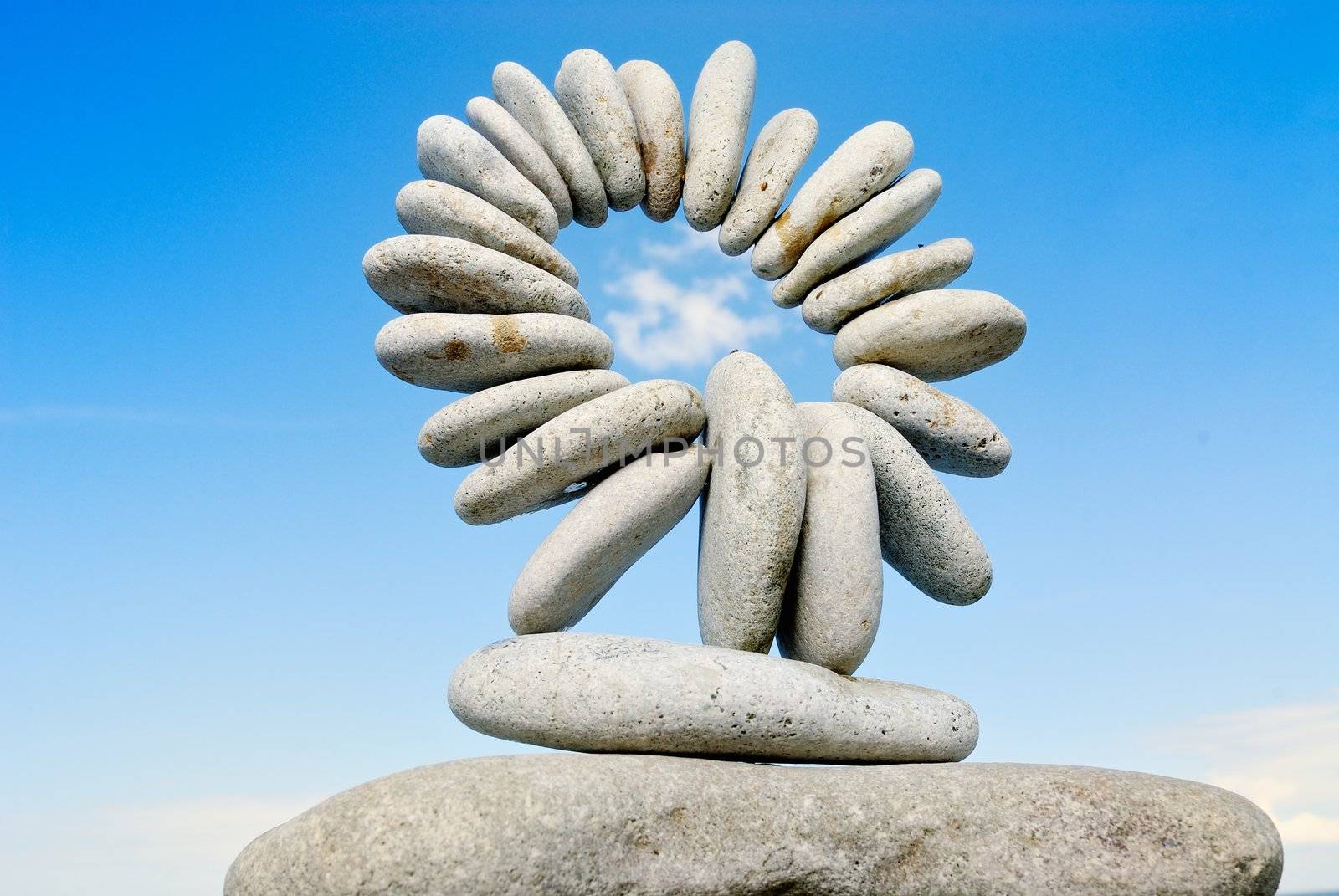 Sea pebble combined in the form of a circle against the sky