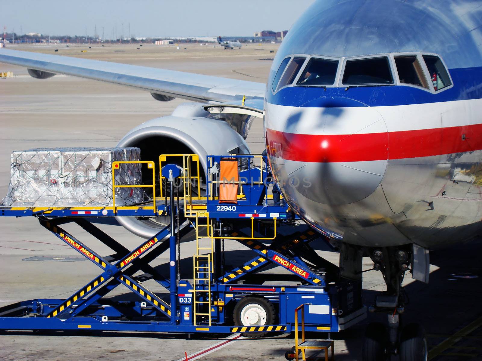 Aircraft loading cargo at International airport.