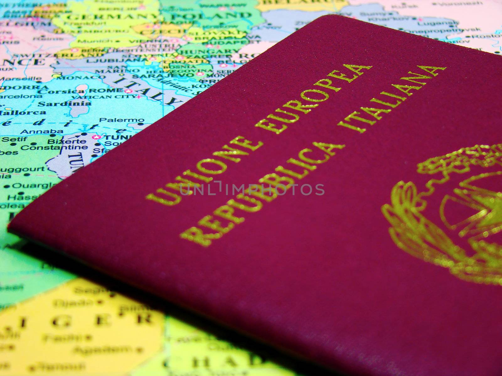 Photo of an Italian passport against map of Europe.