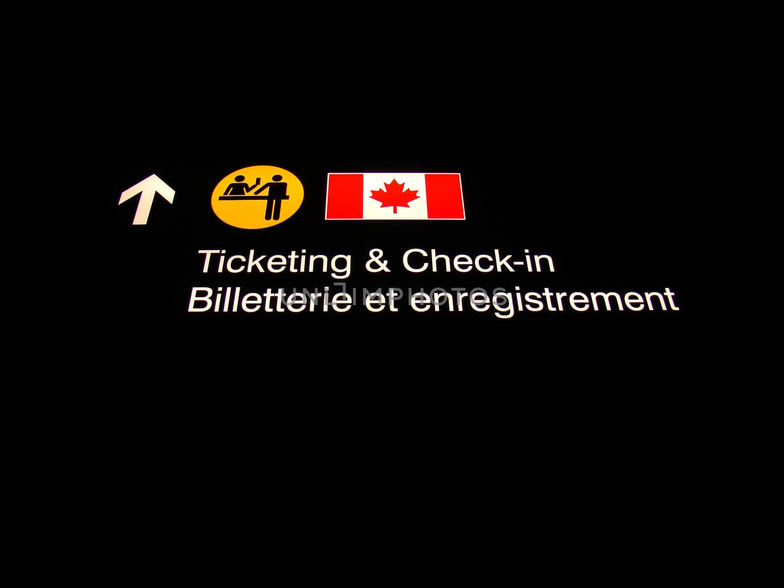 Ticketing and check-in sign at Canadian International airport.