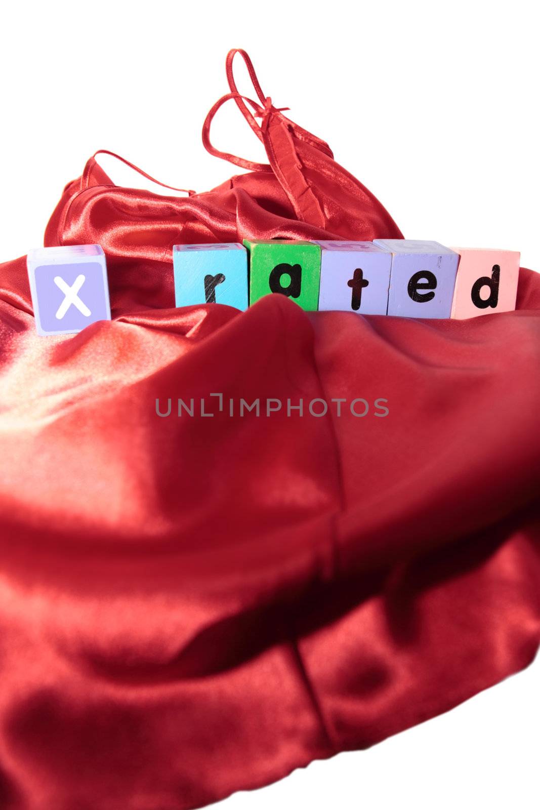 x rated written with blocks on a silk nightie against white background