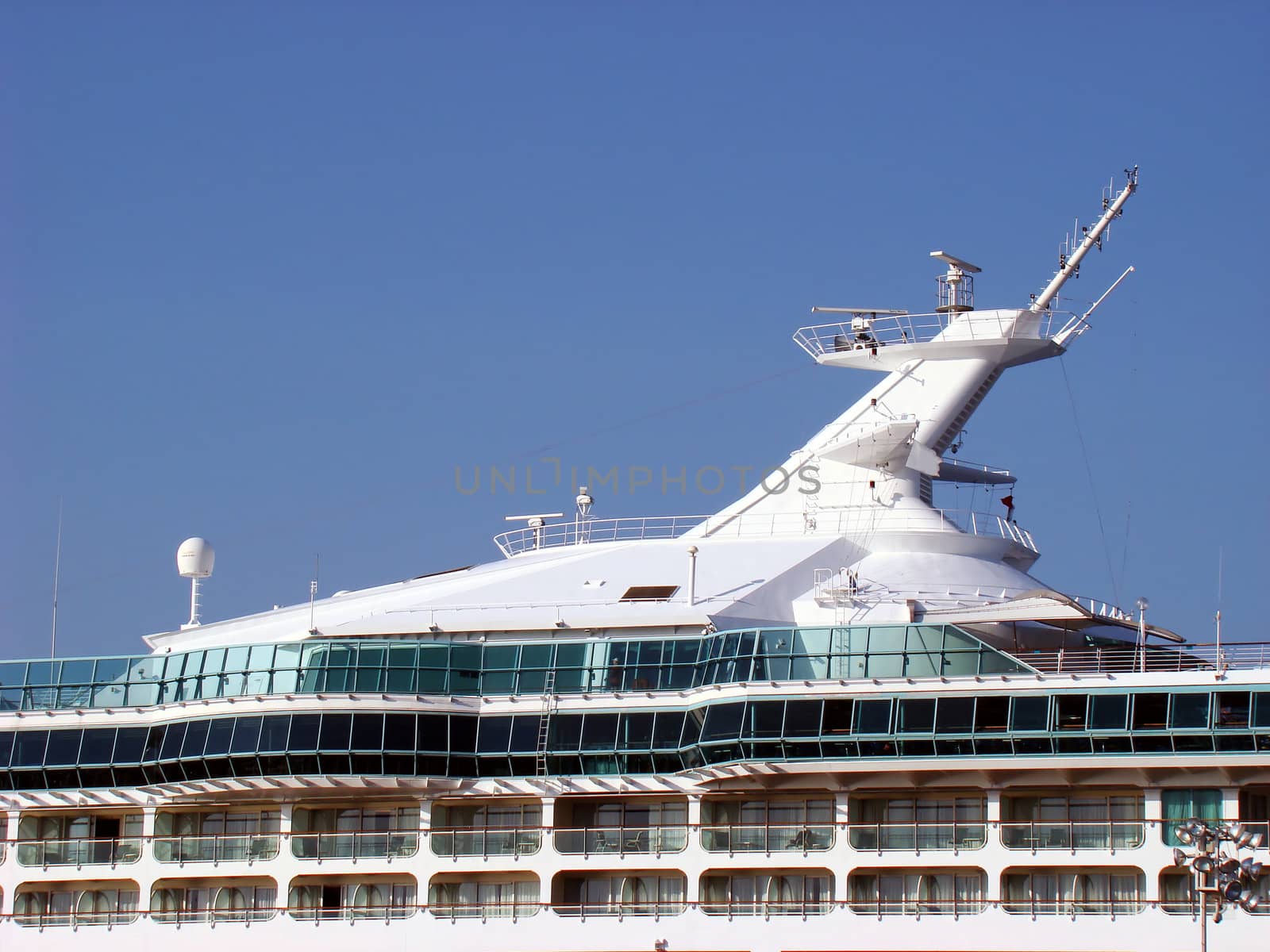 Upper deck of a cruise ship under clear sky.