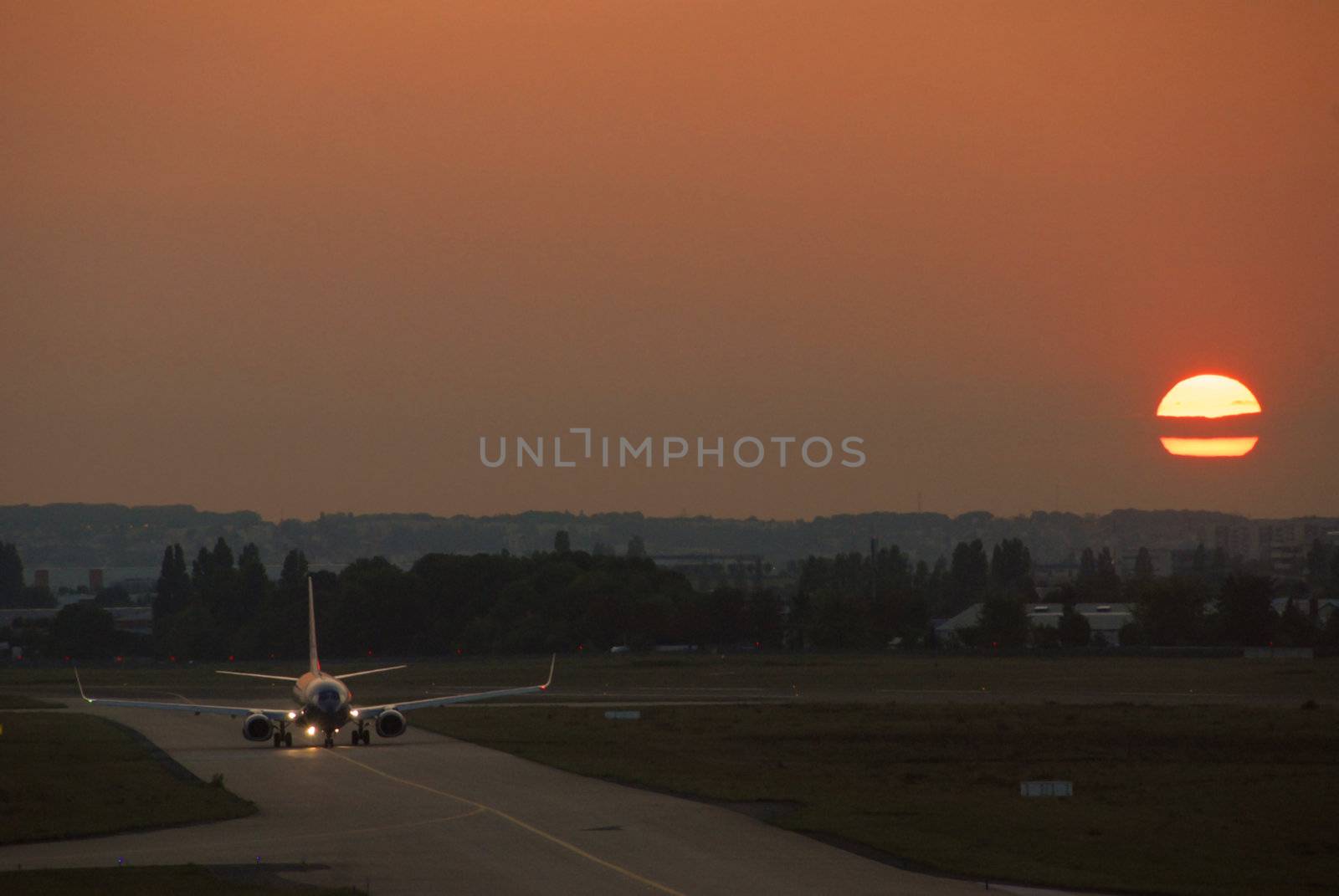 plane in the airport in the suhshine in the evening