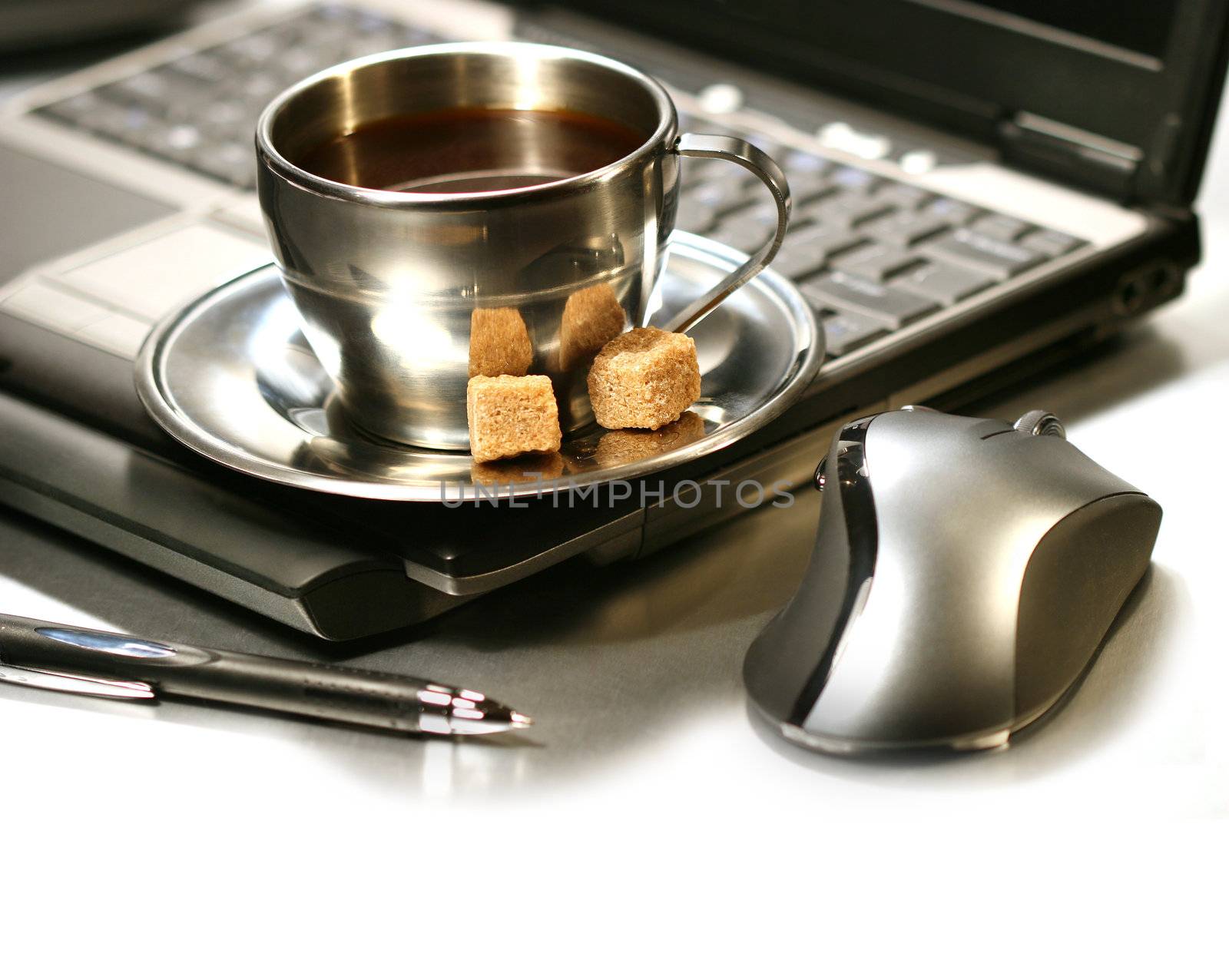 Morning coffee break  with laptop,pen and computer mouse