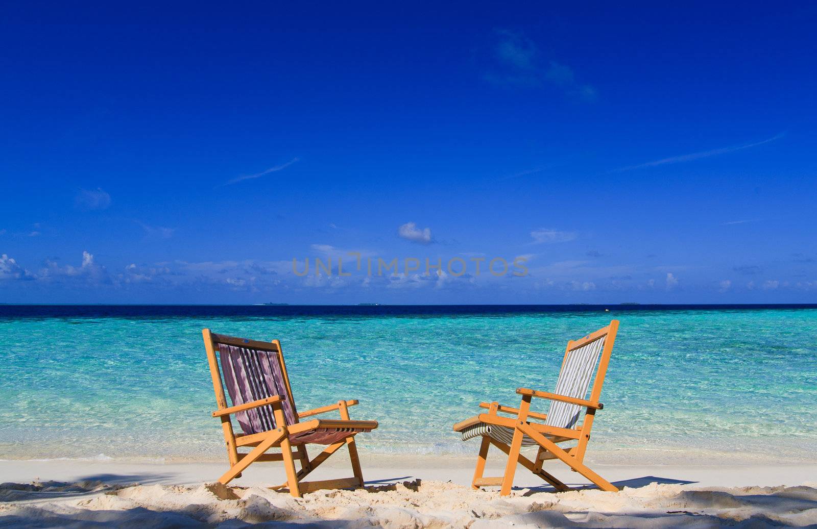 Relaxing on tropical paradise with white sand at Maldives and green palms with blue sky