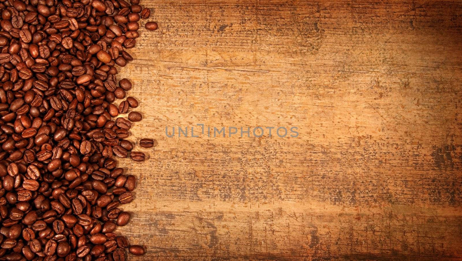 Roasted coffee beans on rustic wood background
