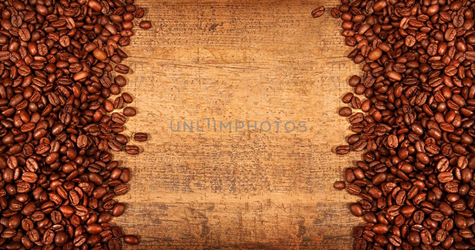 Roasted coffee beans on rustic wood background
