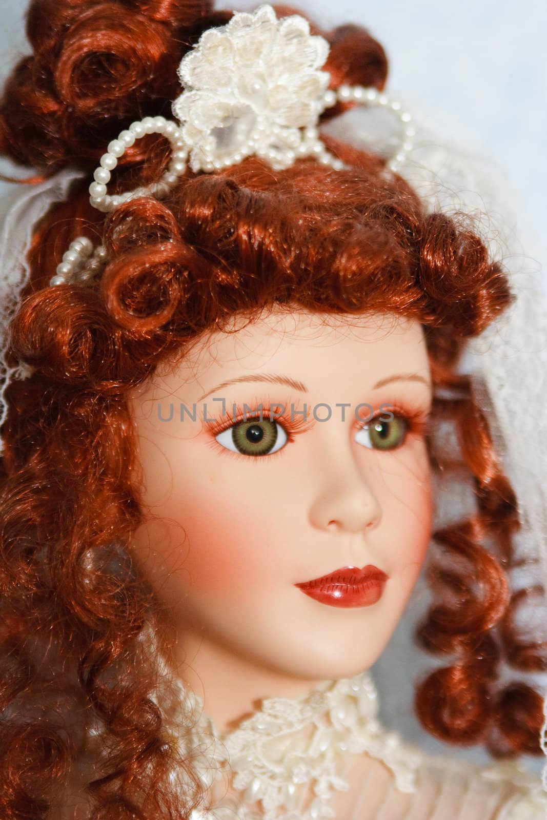 A close up of a young innocent doll face