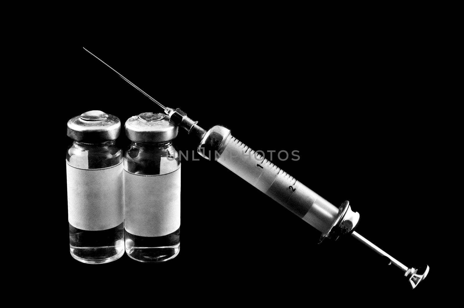syringe and medicaments on a black backgroun  by galcka