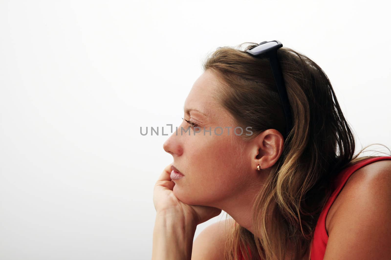 Portrait of the thoughtful woman on a white background