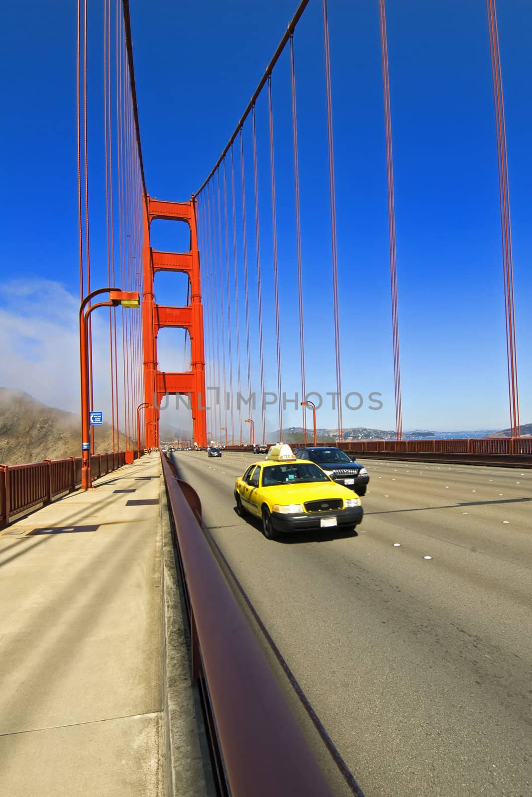 Yellow taxi crossing the Golden Gate Bridge in San Francisco, California, USA