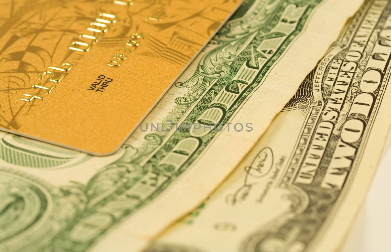 Gold credit card on dollar bank notes by serpl