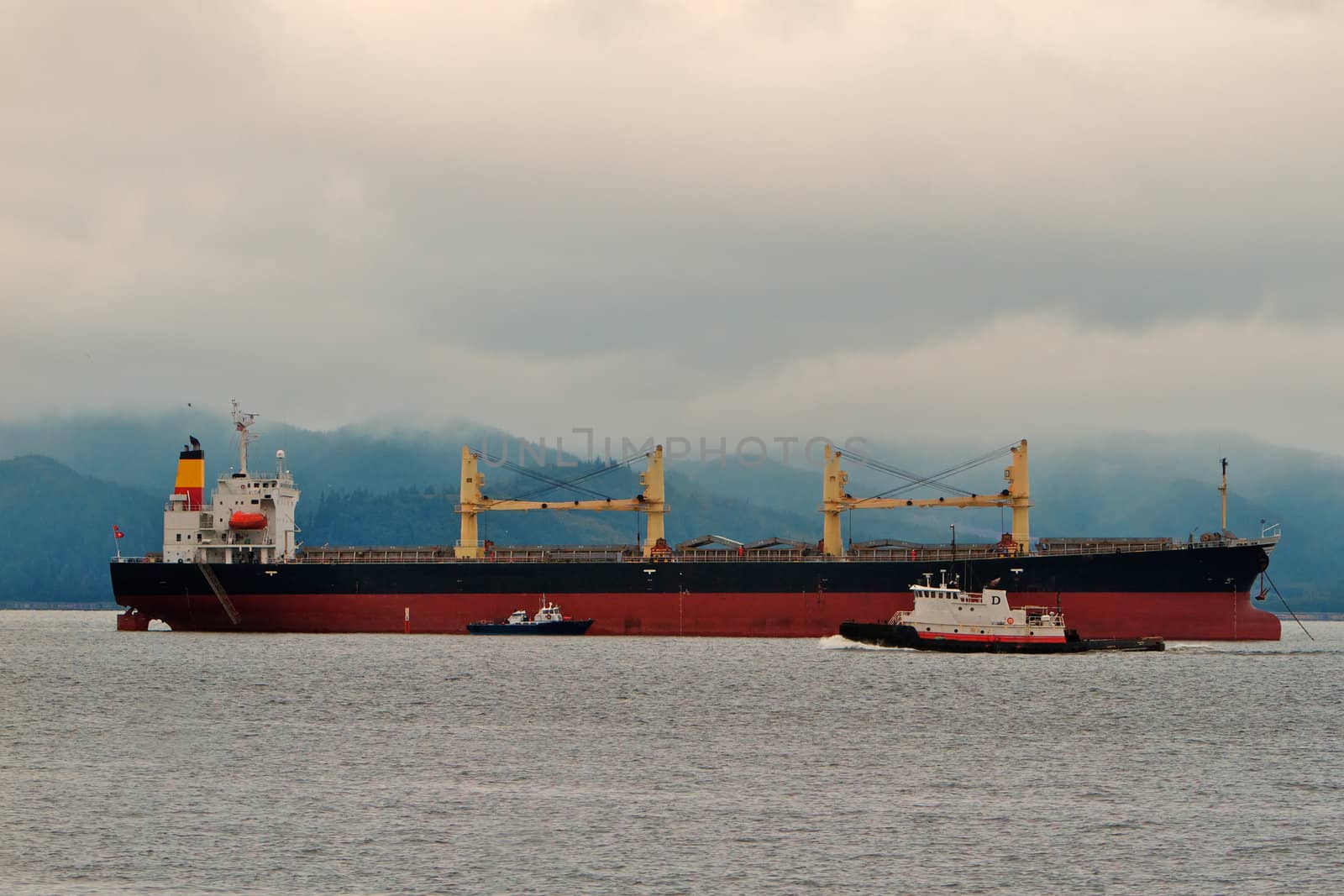Freighter ship tug and pilot vessel at mouth of the columbia river