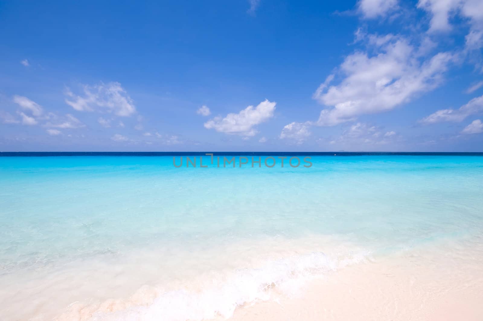 tropical turquoise sea landscape with clouds at horizon
