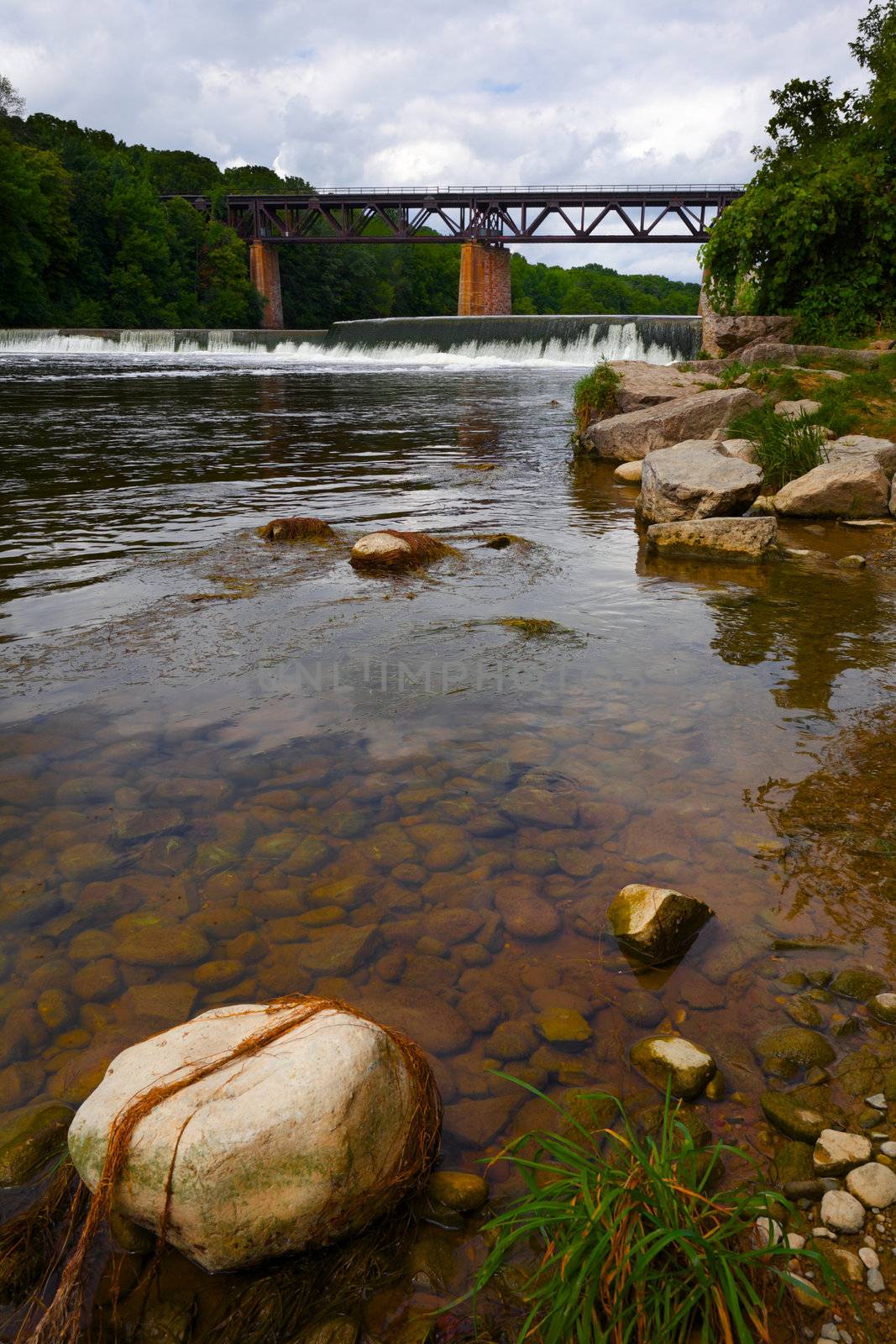 River view showing the train bridge and dam as it flows past Paris, Ontario, Canada