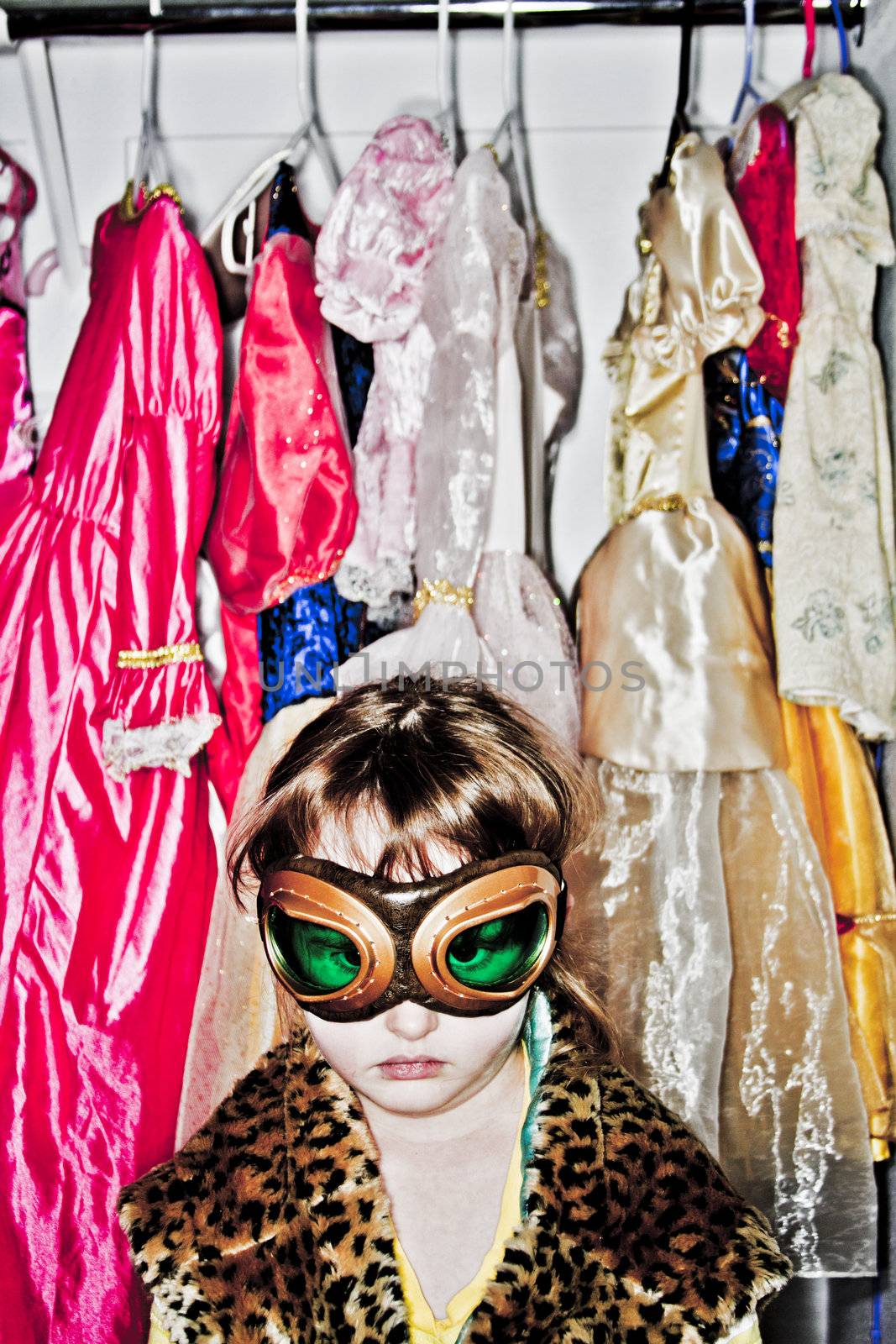 Young girl playing dressup with aviation goggles