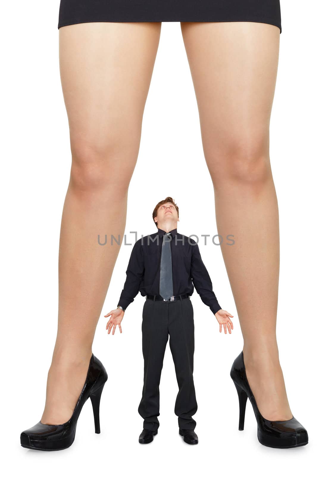 Female legs and little amazed man on white background