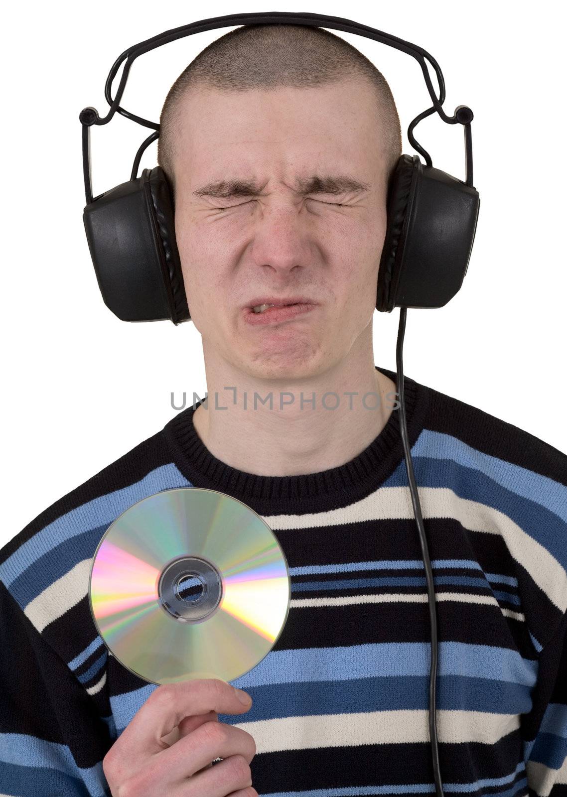 The young guy with ear-phones on a head and compact disk in hand