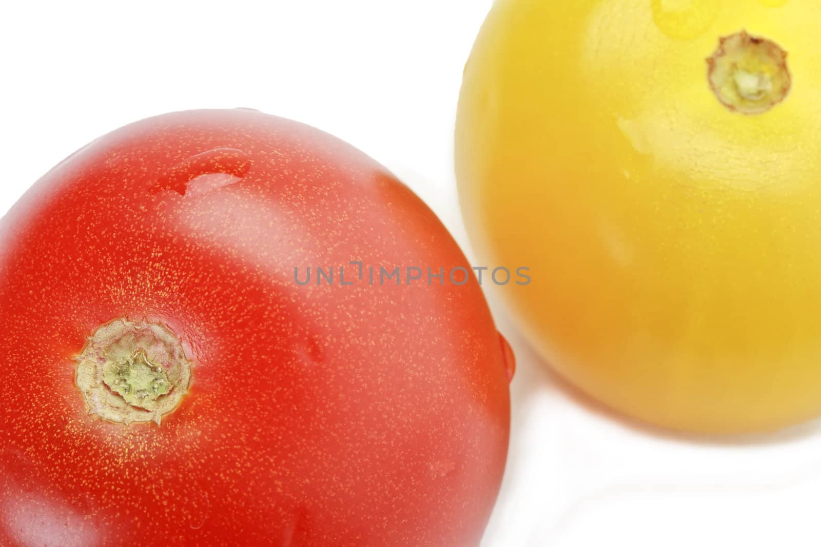 Fresh ripe red and yellow cocktail tomatoes isolated on white