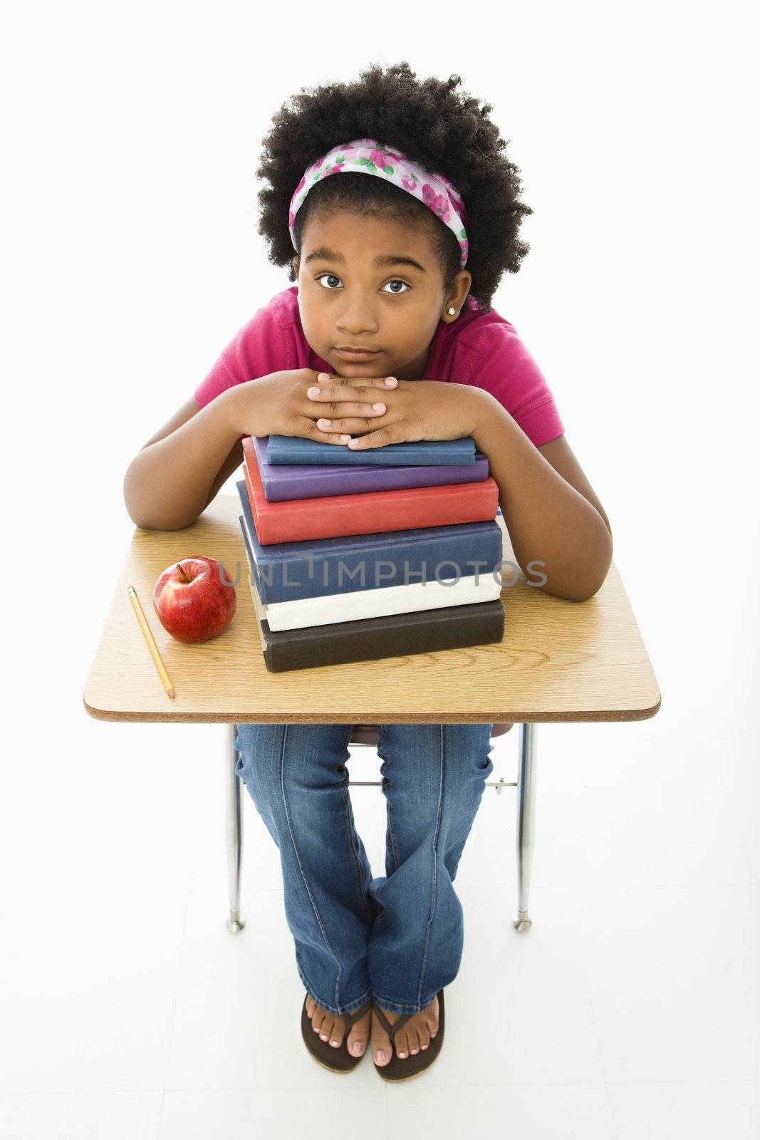 Girl at school desk by iofoto