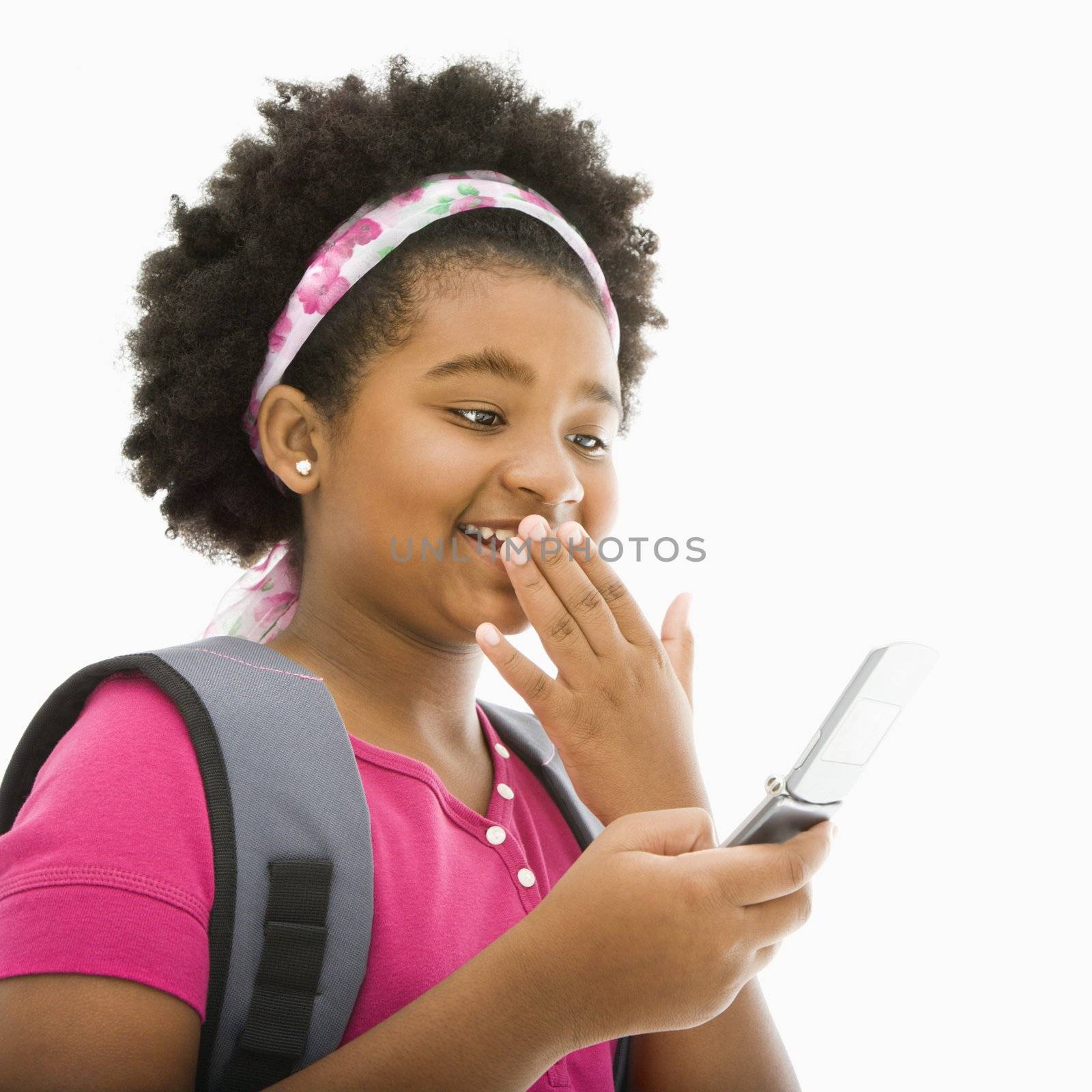 African American girl with backpack talking on cell phone.