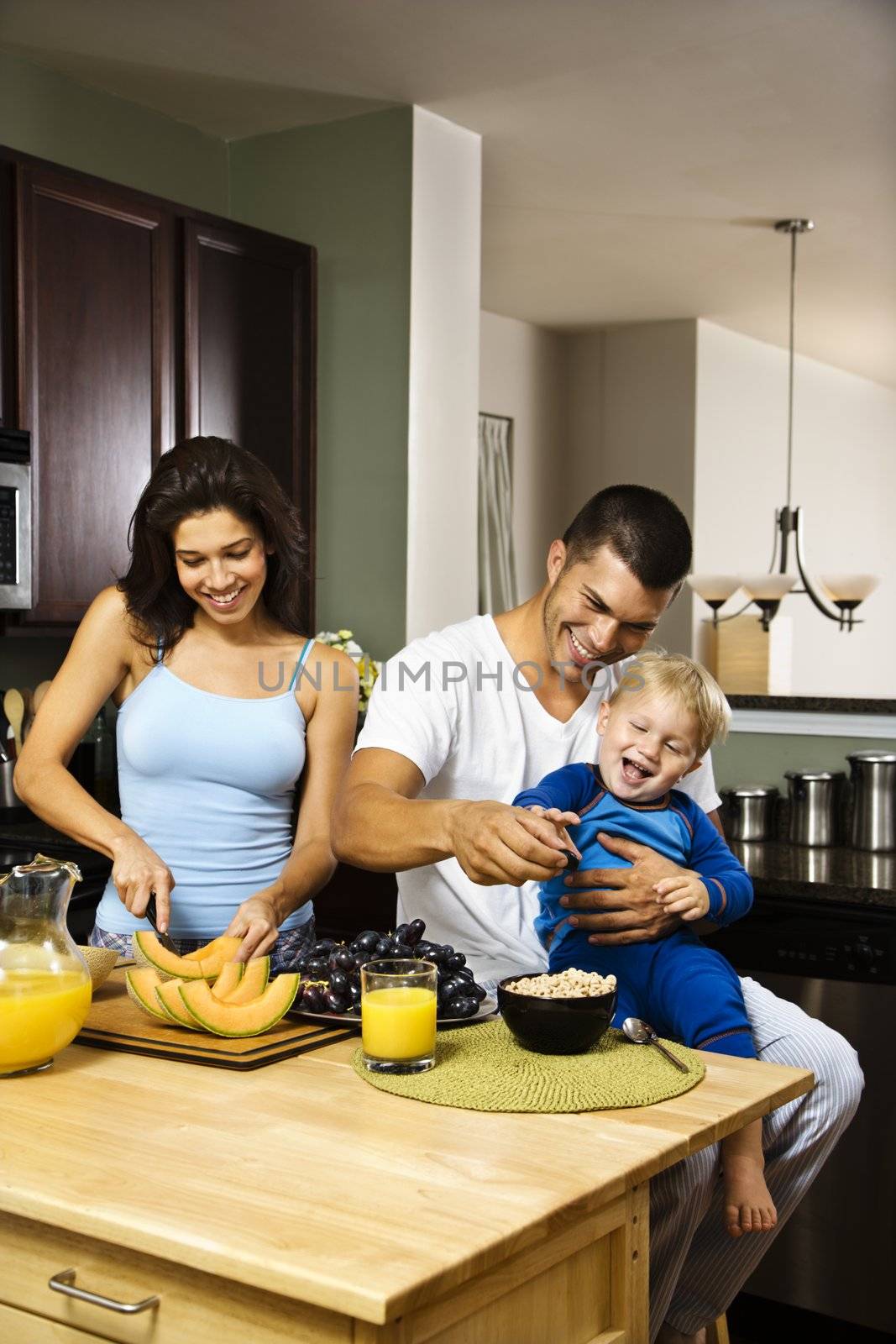 Family in kitchen. by iofoto