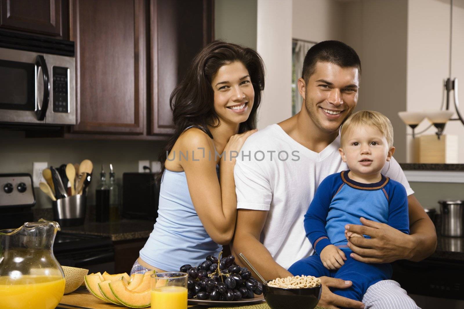 Family in kitchen. by iofoto